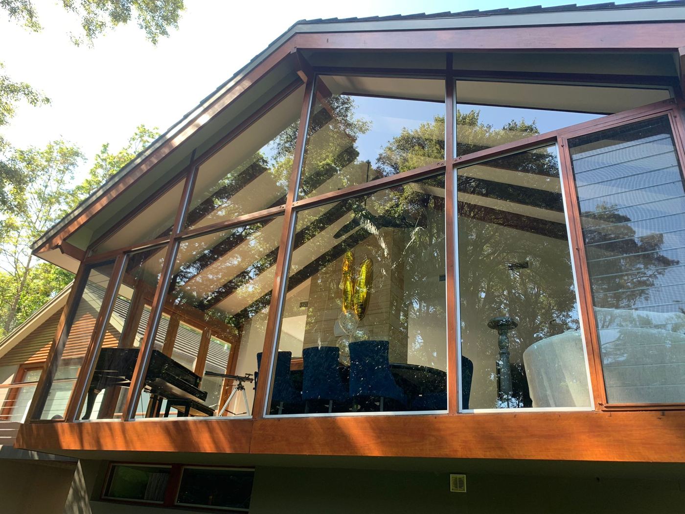 Large timber-framed gable windows on a two-storey home